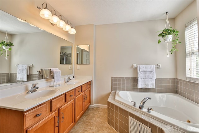 full bath with a sink, tile patterned flooring, plenty of natural light, and a bath