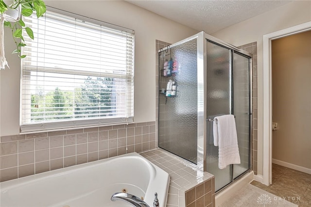 full bathroom featuring a whirlpool tub, tile patterned floors, and a stall shower