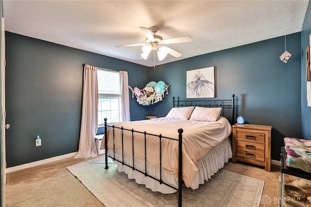 bedroom with baseboards, a textured ceiling, carpet, and ceiling fan