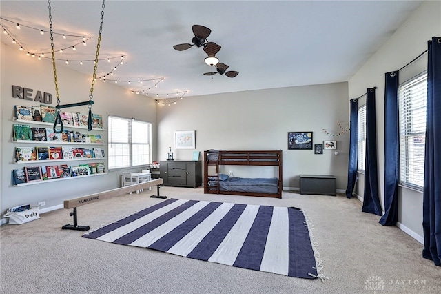 carpeted bedroom featuring baseboards and multiple windows