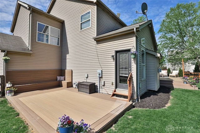 back of property with a lawn and a wooden deck