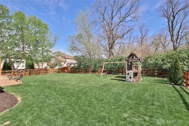 view of yard with a playground and a fenced backyard