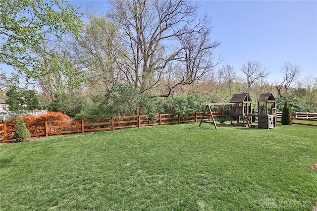 view of yard featuring a fenced backyard and a playground