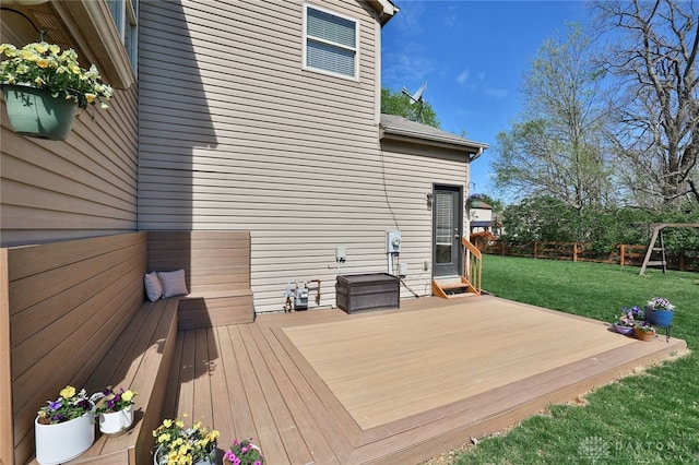 wooden deck featuring a yard and fence