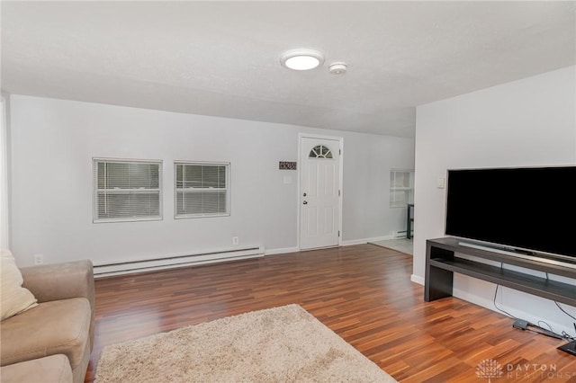 12 N Water St, Lebanon, OH 45036 - living area featuring a baseboard heating unit, wood finished floors, and baseboards
