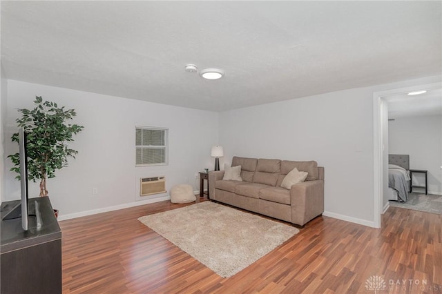 12 N Water St, Lebanon, OH 45036 - living area with wood finished floors, baseboards, and a wall unit AC