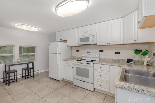 12 N Water St, Lebanon, OH 45036 - kitchen featuring white appliances, a sink, baseboard heating, light countertops, and light tile patterned floors