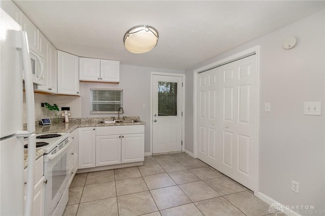 12 N Water St, Lebanon, OH 45036 - kitchen featuring white appliances, a sink, white cabinetry, light tile patterned flooring, and baseboards