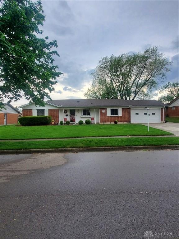 421 Stuckhardt Rd, Dayton, OH 45426 - single story home featuring an attached garage, driveway, brick siding, and a front yard