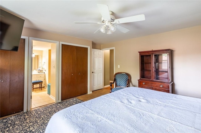 bedroom with tile patterned floors, ceiling fan, a closet, and connected bathroom