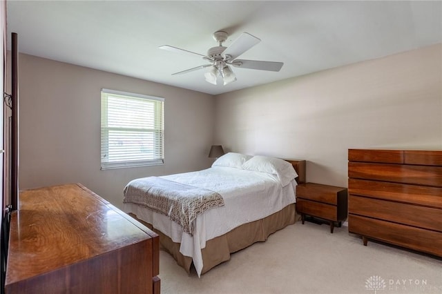 bedroom featuring light colored carpet and a ceiling fan