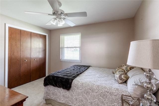 bedroom with a closet, a ceiling fan, and carpet flooring