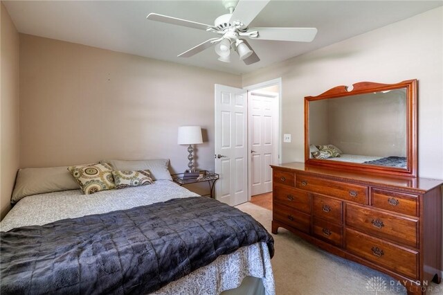 bedroom with ceiling fan and light carpet