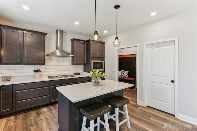 2187 Hamilton Rd, Lebanon, OH 45036 - kitchen with a kitchen breakfast bar, dark brown cabinetry, dark wood-style flooring, tasteful backsplash, and wall chimney exhaust hood