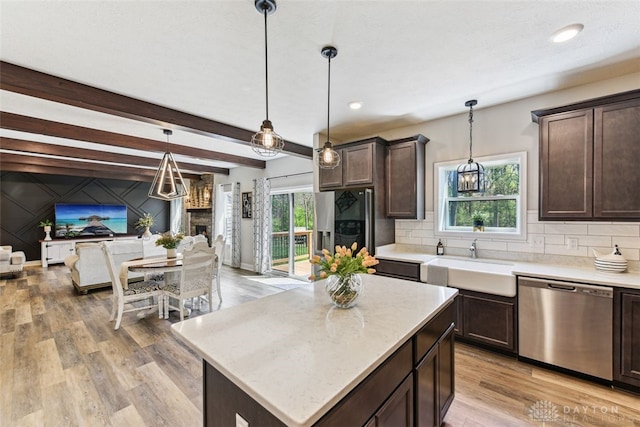 2187 Hamilton Rd, Lebanon, OH 45036 - kitchen featuring dark brown cabinets, light wood-style floors, open floor plan, decorative backsplash, and stainless steel dishwasher
