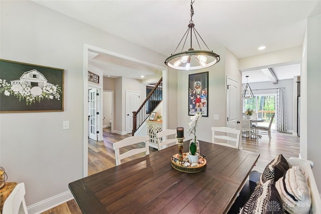 2187 Hamilton Rd, Lebanon, OH 45036 - dining area featuring an inviting chandelier, wood finished floors, baseboards, stairway, and french doors