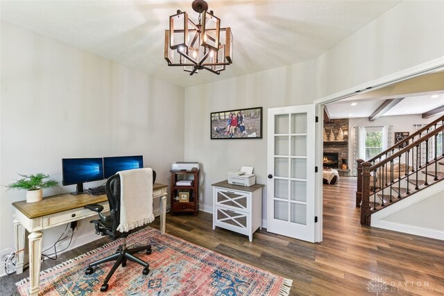 2187 Hamilton Rd, Lebanon, OH 45036 - office with baseboards, wood finished floors, a notable chandelier, and a fireplace