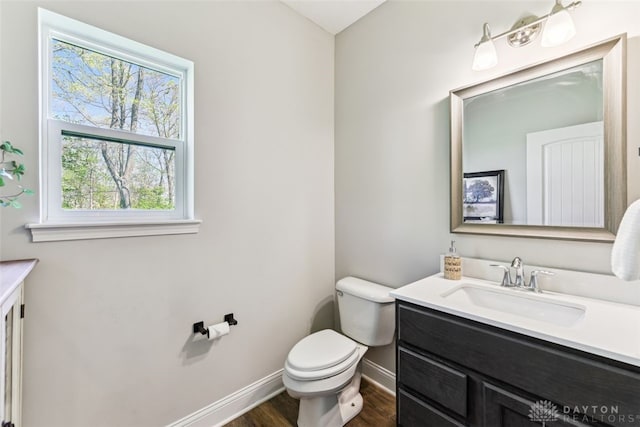 2187 Hamilton Rd, Lebanon, OH 45036 - half bathroom with baseboards, wood finished floors, toilet, and vanity