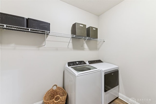 2187 Hamilton Rd, Lebanon, OH 45036 - washroom with baseboards, laundry area, washer and clothes dryer, and wood finished floors