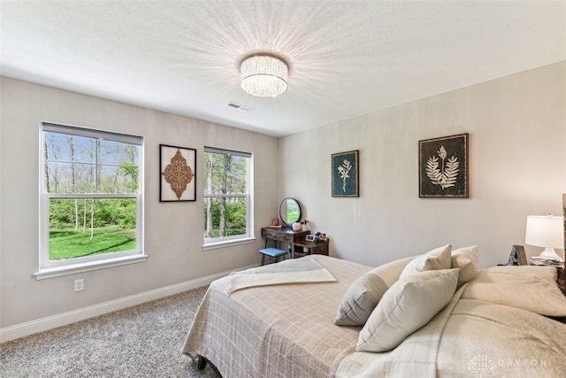 2187 Hamilton Rd, Lebanon, OH 45036 - carpeted bedroom featuring baseboards, visible vents, and an inviting chandelier