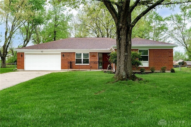 3600 Honeybrook Ave, Dayton, OH 45415 - ranch-style house with brick siding, driveway, a front yard, and a garage