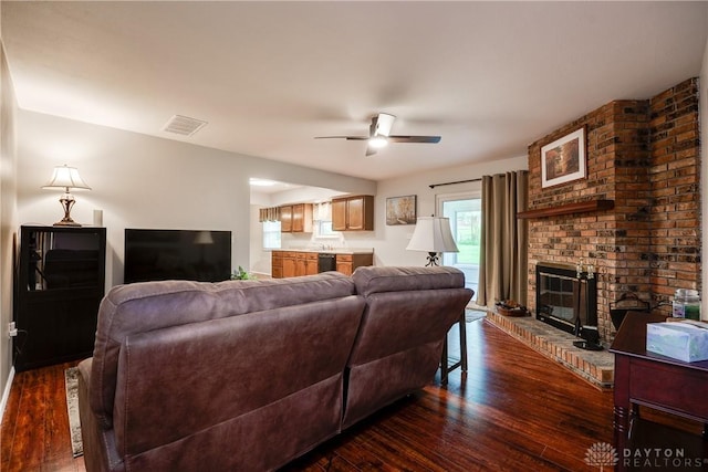 3600 Honeybrook Ave, Dayton, OH 45415 - living area with ceiling fan, a brick fireplace, dark wood finished floors, and visible vents