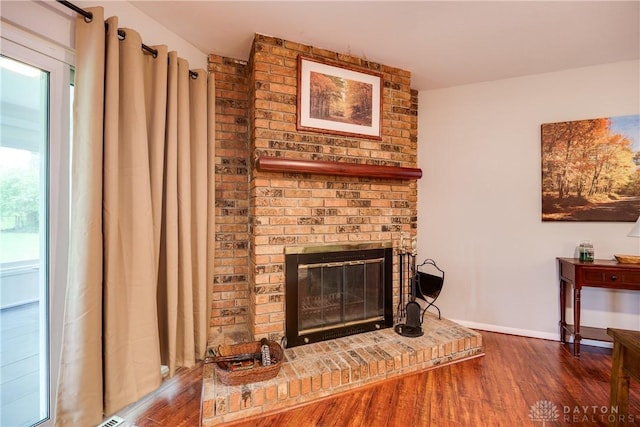 3600 Honeybrook Ave, Dayton, OH 45415 - living area with a brick fireplace, baseboards, and wood finished floors