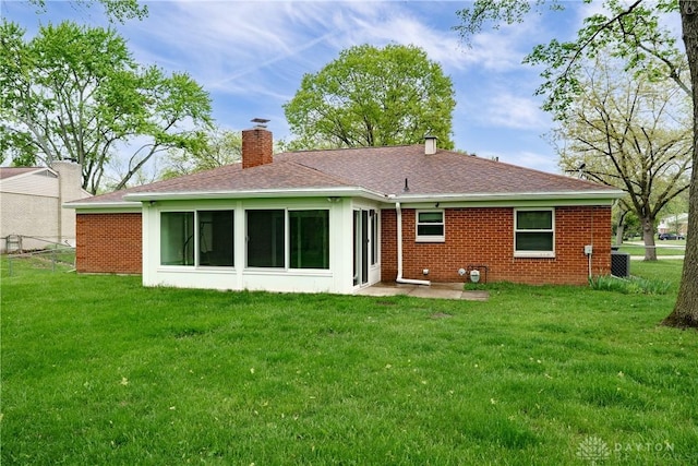 3600 Honeybrook Ave, Dayton, OH 45415 - rear view of house with a chimney, brick siding, central AC unit, a shingled roof, and a yard