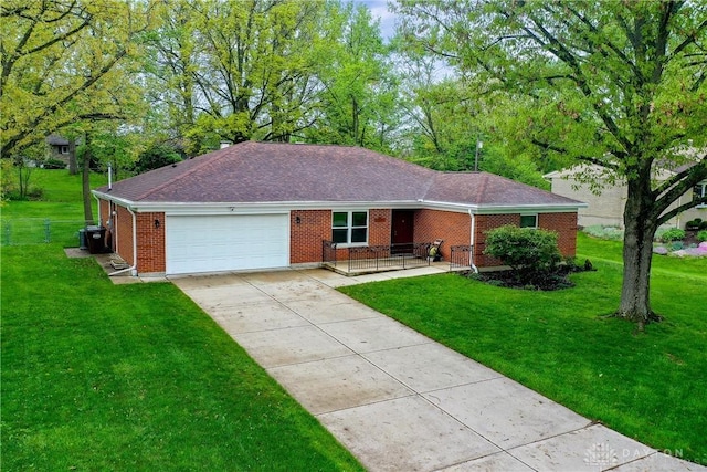 3600 Honeybrook Ave, Dayton, OH 45415 - ranch-style house with brick siding, an attached garage, driveway, and a front lawn
