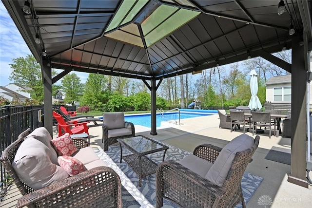 7633 Hargus Dr, Maineville, OH 45039 - view of patio featuring fence, outdoor dining space, a gazebo, an outdoor hangout area, and a fenced in pool