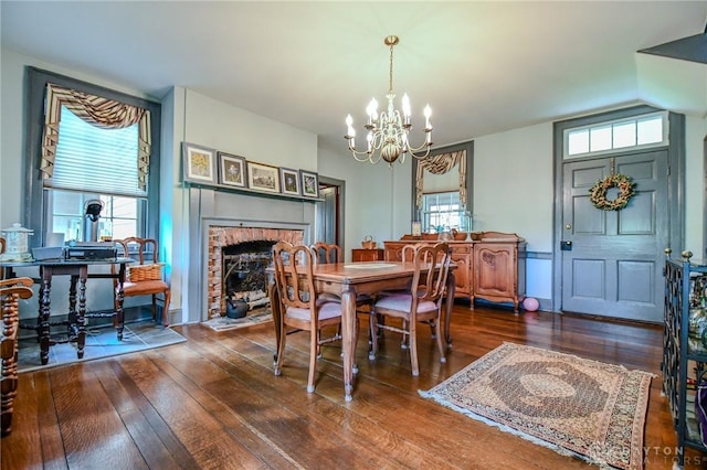 2100 Wagner Trace Dr, Beavercreek, OH 45431 - dining space featuring a fireplace, a chandelier, and hardwood / wood-style flooring