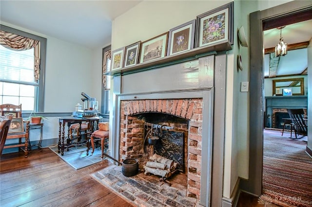 room details with a brick fireplace and wood finished floors