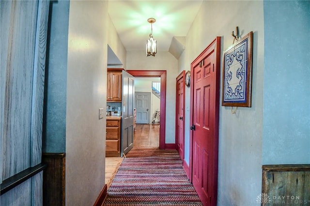 hallway with a notable chandelier