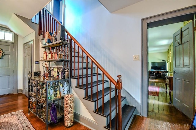 stairs with wood-type flooring and baseboards