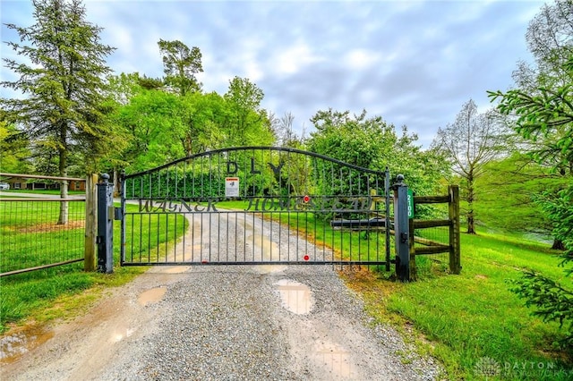 view of gate featuring a yard
