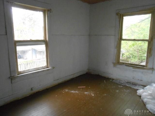 spare room with plenty of natural light and hardwood / wood-style flooring