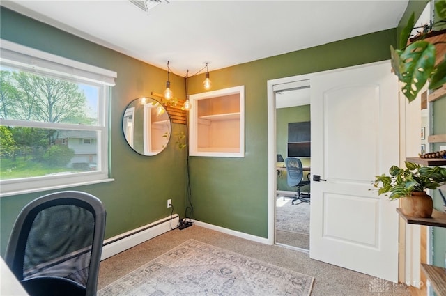 office area featuring baseboards, carpet flooring, a baseboard heating unit, and visible vents