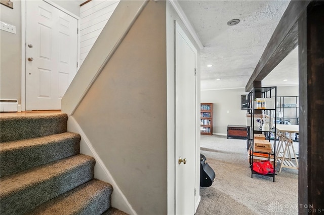 stairs featuring carpet floors and a baseboard radiator
