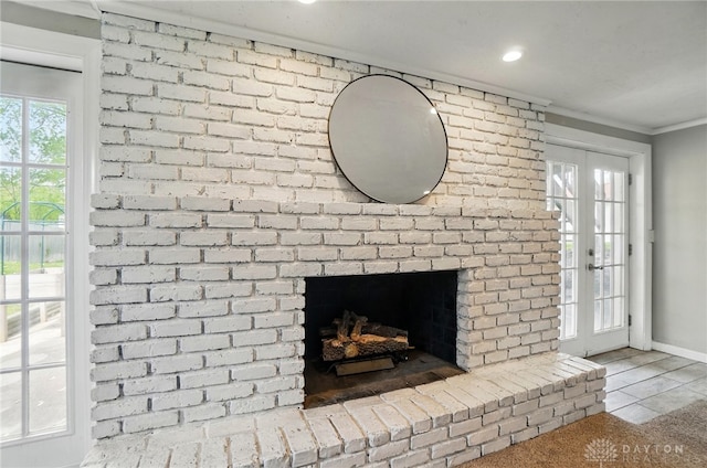 room details with baseboards, ornamental molding, a brick fireplace, and recessed lighting