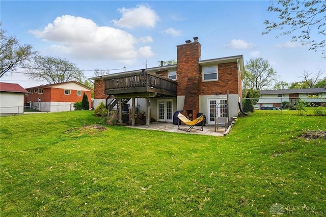 back of property featuring fence, french doors, a patio area, and a wooden deck