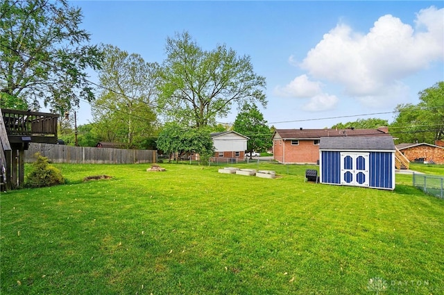 view of yard with a storage unit, a fenced backyard, and an outdoor structure