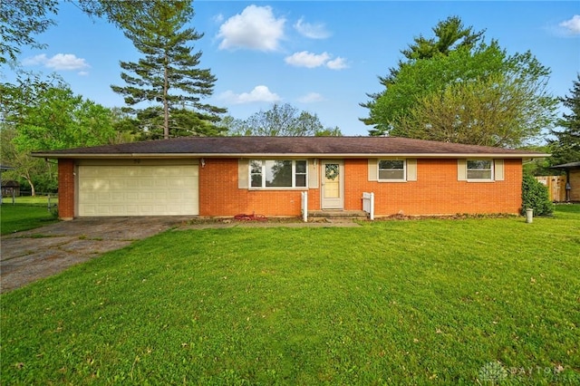 59 Janet Ave, Carlisle, OH 45005 - single story home with brick siding, a garage, driveway, and a front yard