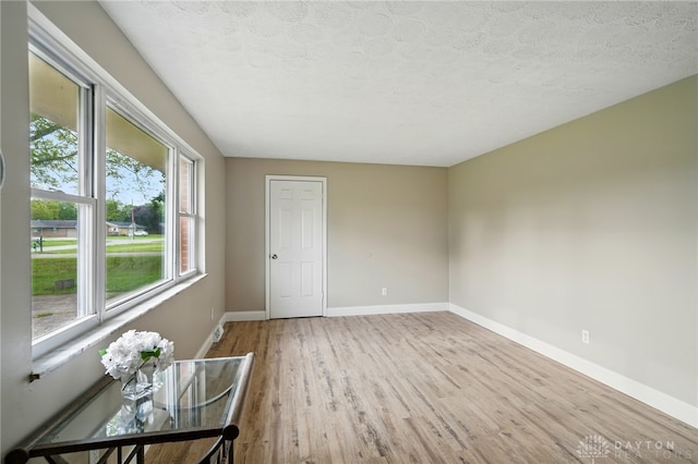 59 Janet Ave, Carlisle, OH 45005 - spare room featuring a textured ceiling, baseboards, and wood finished floors