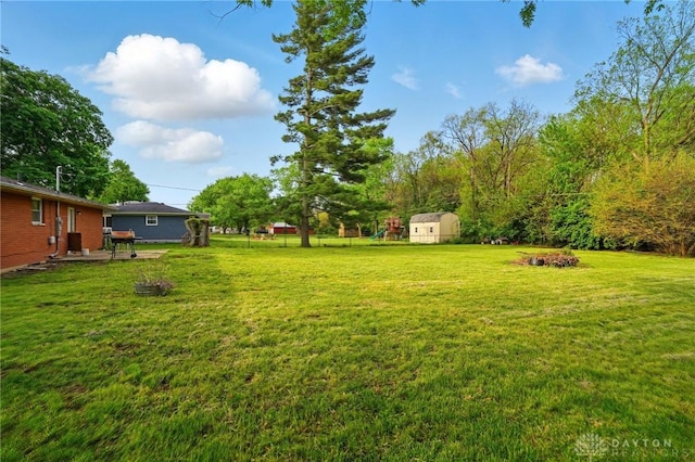 59 Janet Ave, Carlisle, OH 45005 - view of yard featuring an outdoor structure and a storage shed