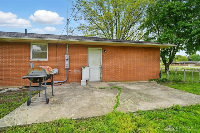 59 Janet Ave, Carlisle, OH 45005 - back of property featuring fence, a patio area, and brick siding