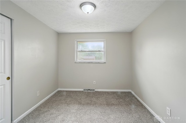 59 Janet Ave, Carlisle, OH 45005 - empty room with baseboards, carpet flooring, a textured ceiling, and visible vents
