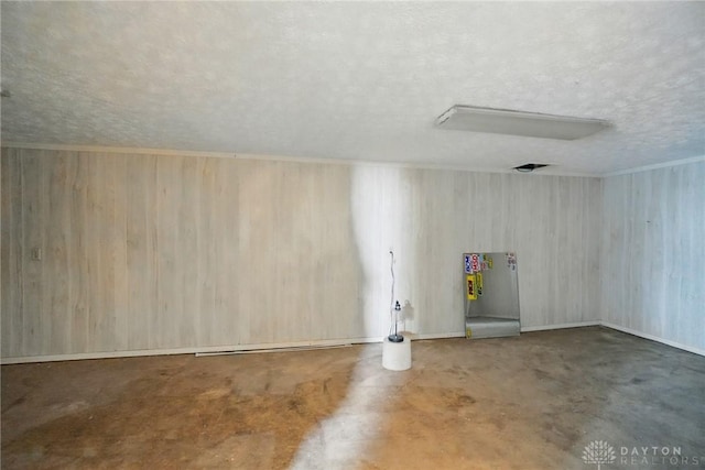 59 Janet Ave, Carlisle, OH 45005 - unfurnished room with a textured ceiling, wood walls, and concrete floors