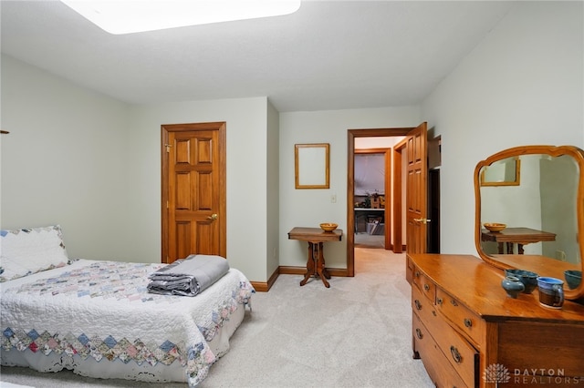 bedroom featuring baseboards and light colored carpet