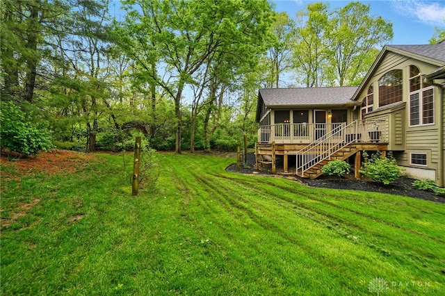 view of yard featuring stairs and a sunroom