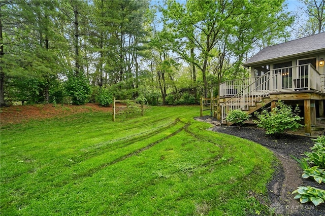 view of yard featuring a deck and stairway